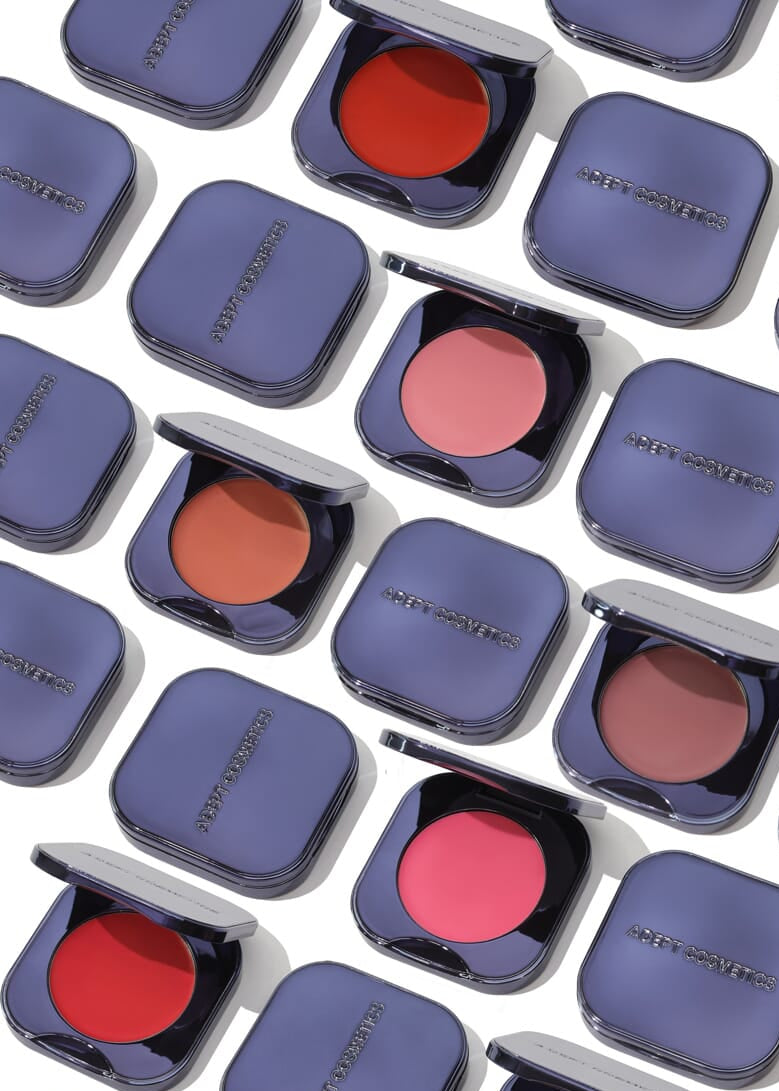 Pattern of open makeup compact cases with blushes on a white background