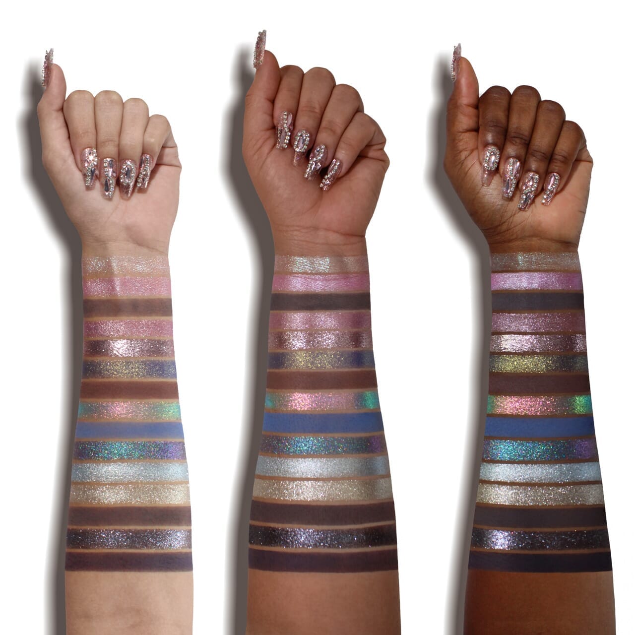 Three hands with multicolored glittery arm bands on a white background