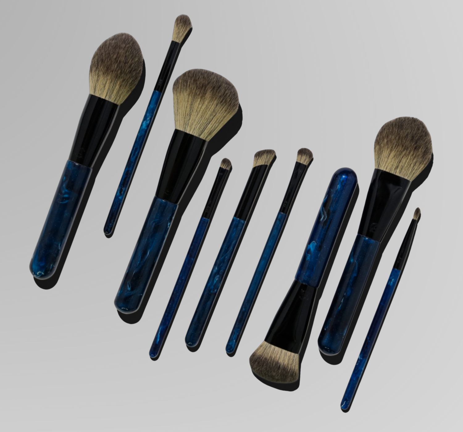 Set of makeup brushes with blue and black handles on a light gray background