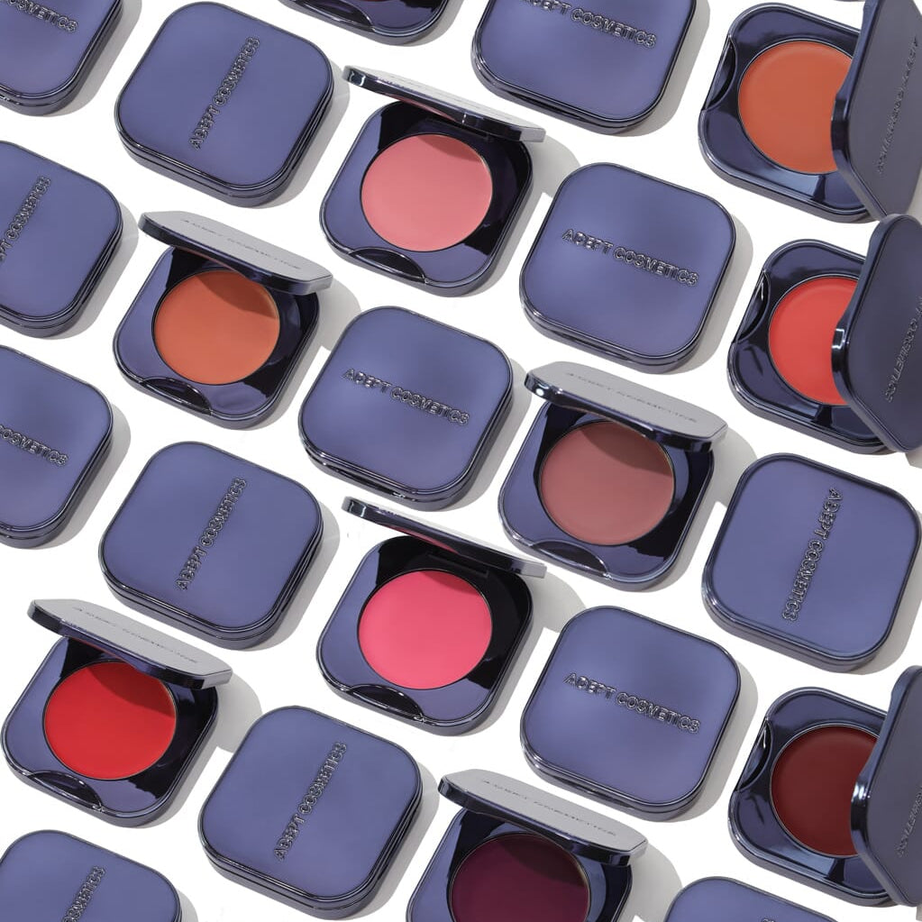 Pattern of open makeup compact cases with blush shades on a white background