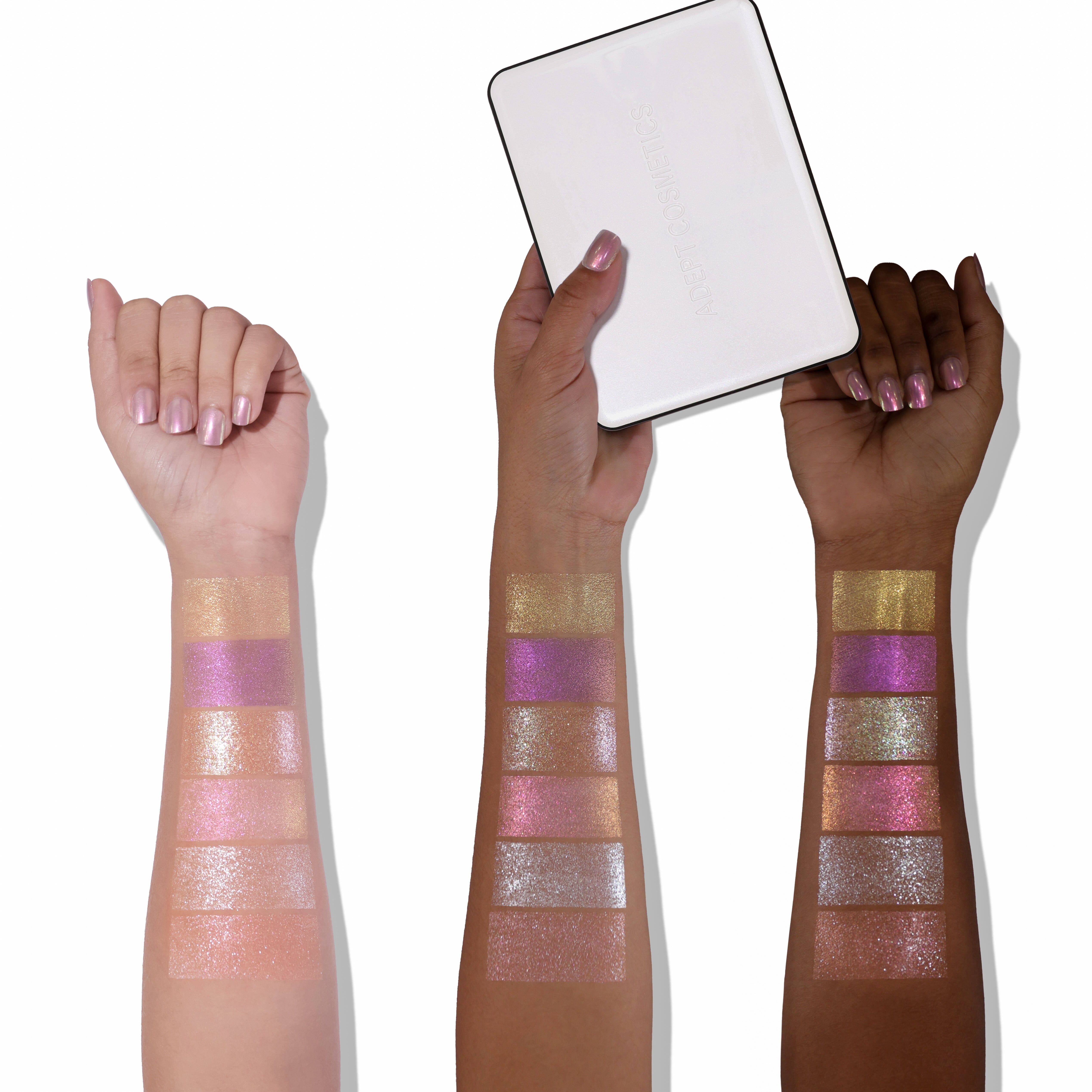 Three arms with colorful glittery arm makeup swatches on a white background