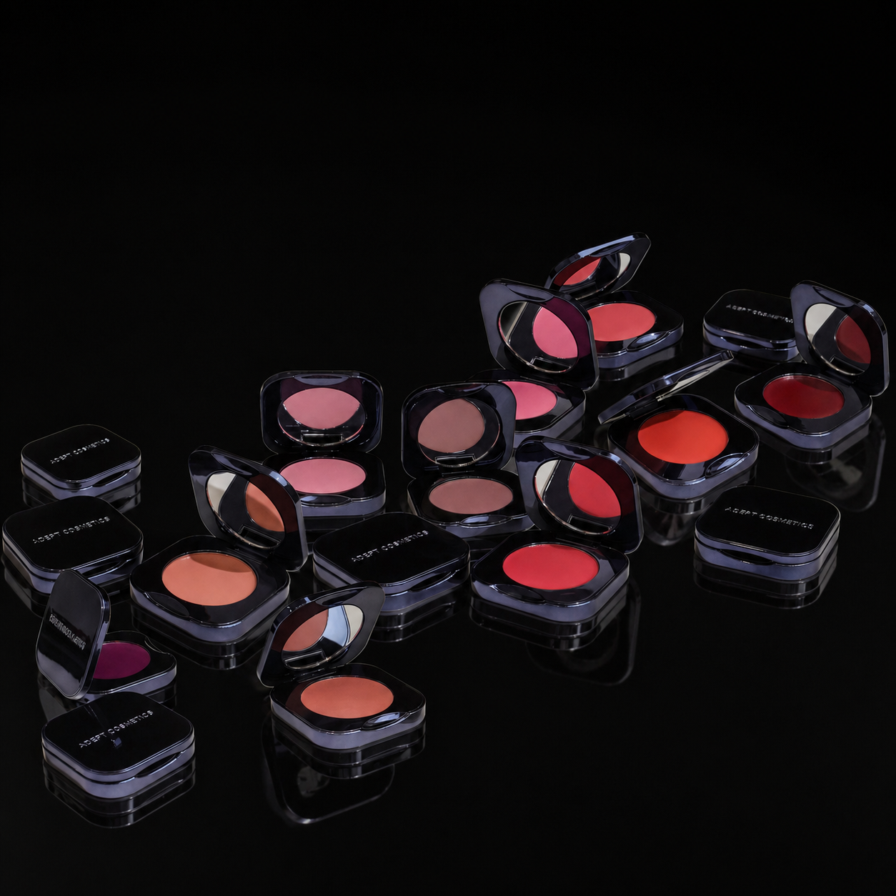 Collection of makeup blushes in various shades on a black background